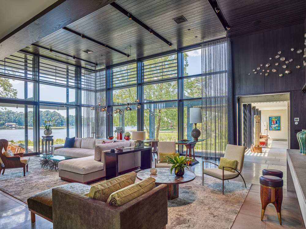 View of Modern High-Ceilinged Living and Dining Room with Ebony Wood Ceiling, Wood Louvers, Concrete/Limestone Floors and Triple-Pane Windows by Top Virginia Architect.