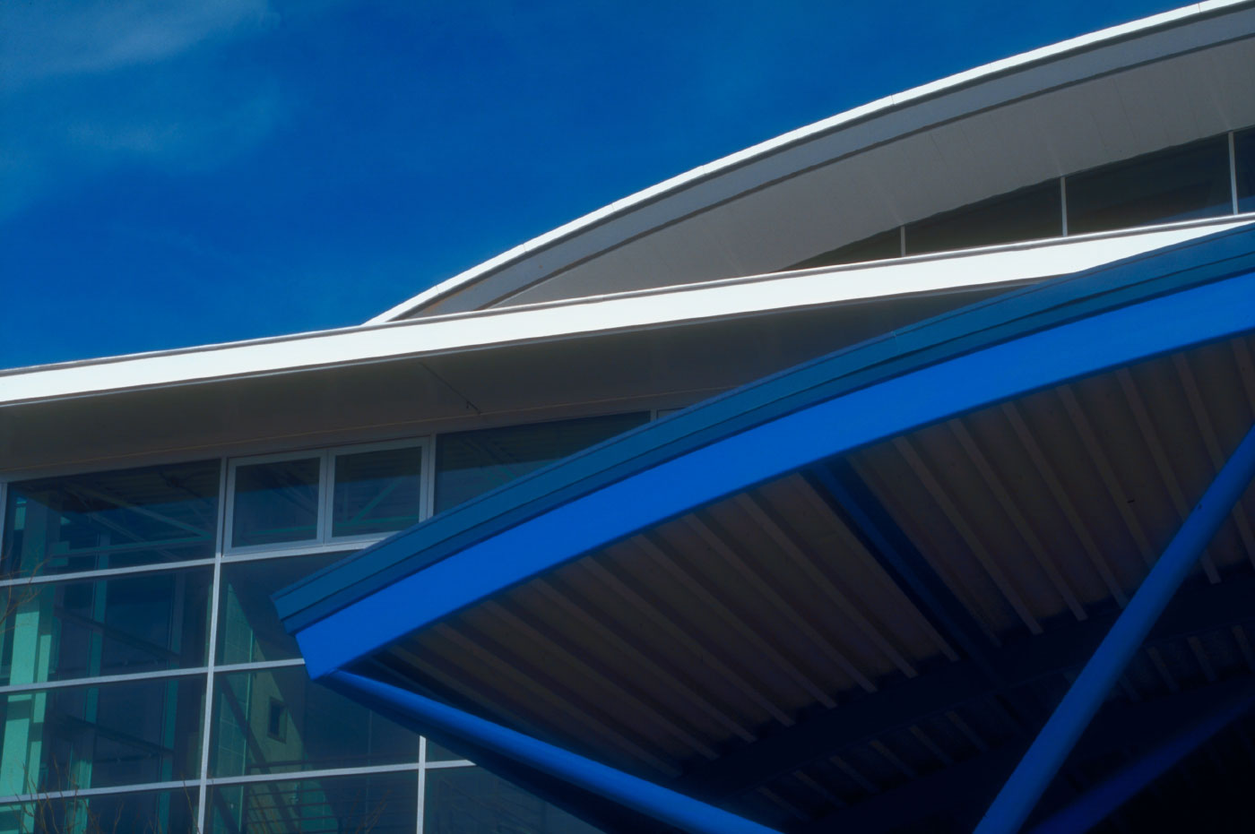 Detail of the Arched Glass and Blue Steel Entrance to the Modern and Green Herman Miller Factory in Traverse City, MI by Virginia Commercial Architect.