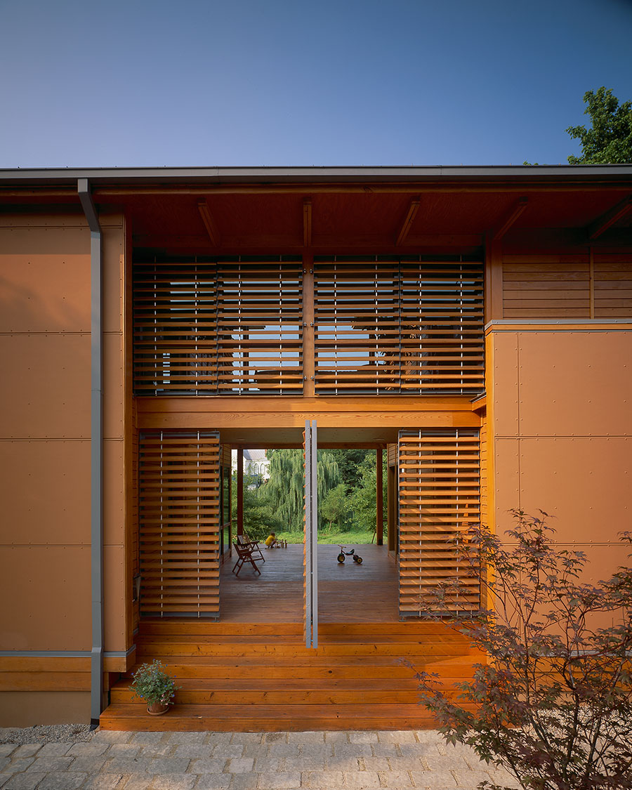 Image of Modern Green Charlottesville Home by HEDS Architects has Stained Wood Shiplap, Plant Trellis and Front Louvered Entrance With Big Pivot Door.