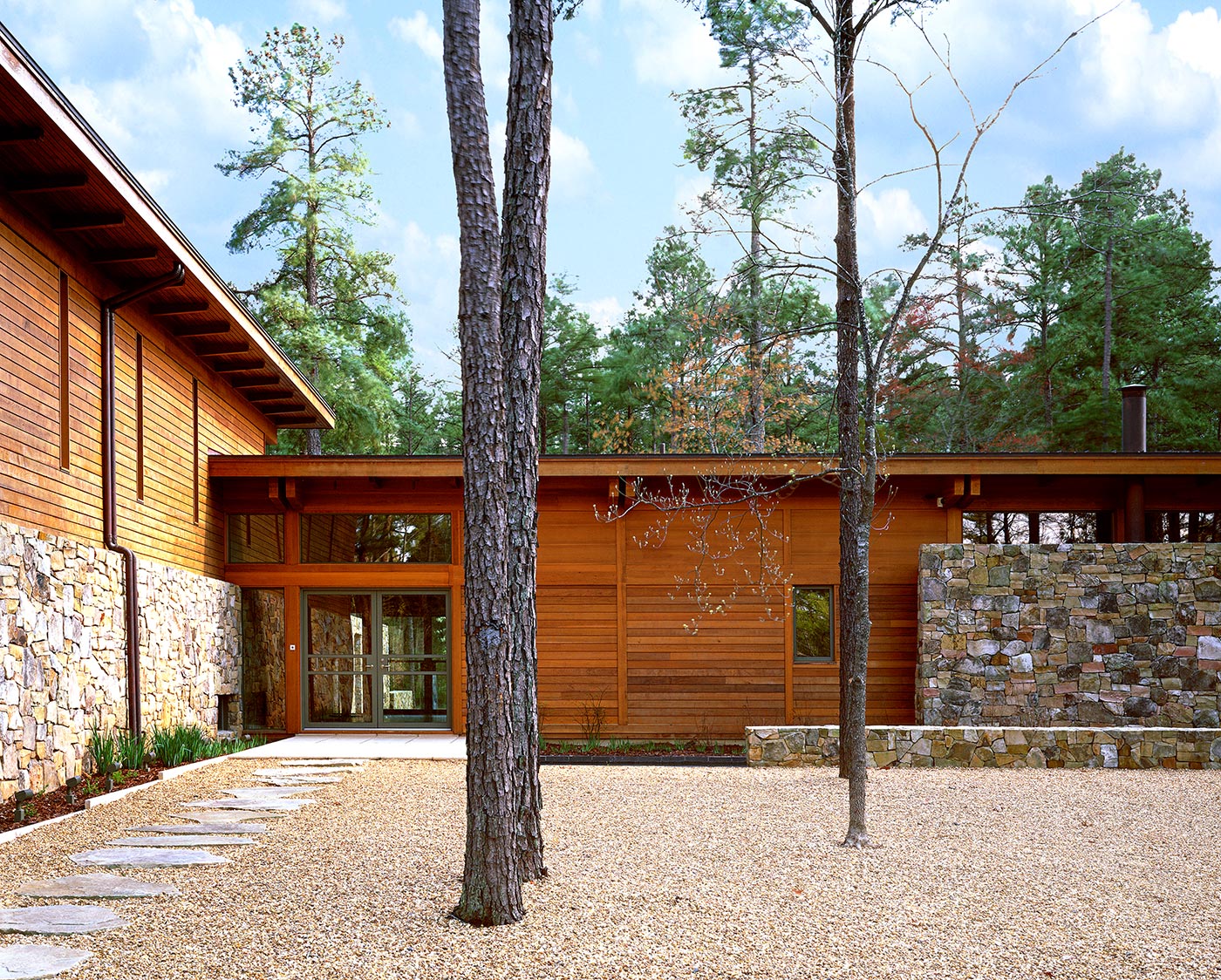 L-Shaped House with Stone and Shiplap Wood Walls in Charlotte, NC Modern Home, Designed by Best Virginia Architects.