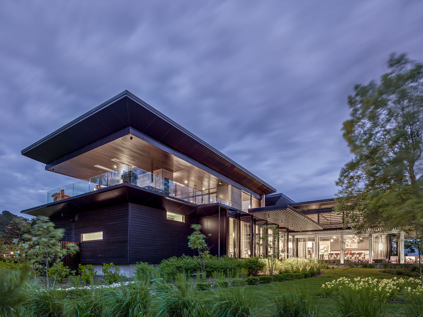 Modern and Green Virginia Beach Home on Linkhorn Bay with Second Floor Covered Porch, Triple Pane Windows, Shou Sugi Ban Wood Siding Dark Stained Trellis, Concrete Walls and Piers, Concrete Paving, Steel Structure and Reynobond Metal Panels by Virginia Beach Architect Allison Ewing.